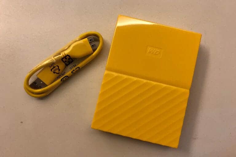 Yellow WD My Passport 4TB portable hard drive with USB cable
