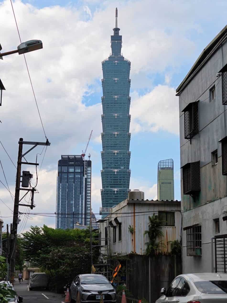 Insta360 Luna Ultra Unboxing: A Small Camera With Big Ambitions 20 Taipei 101 skyscraper dominates a city street view with older buildings in the foreground.